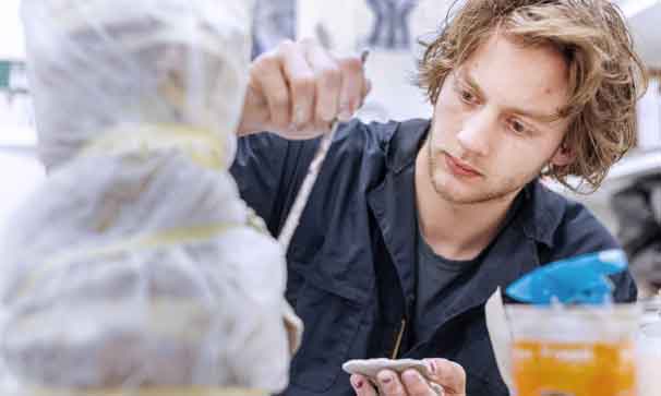 student working on an art project