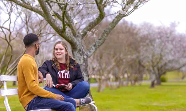 students sitting outside